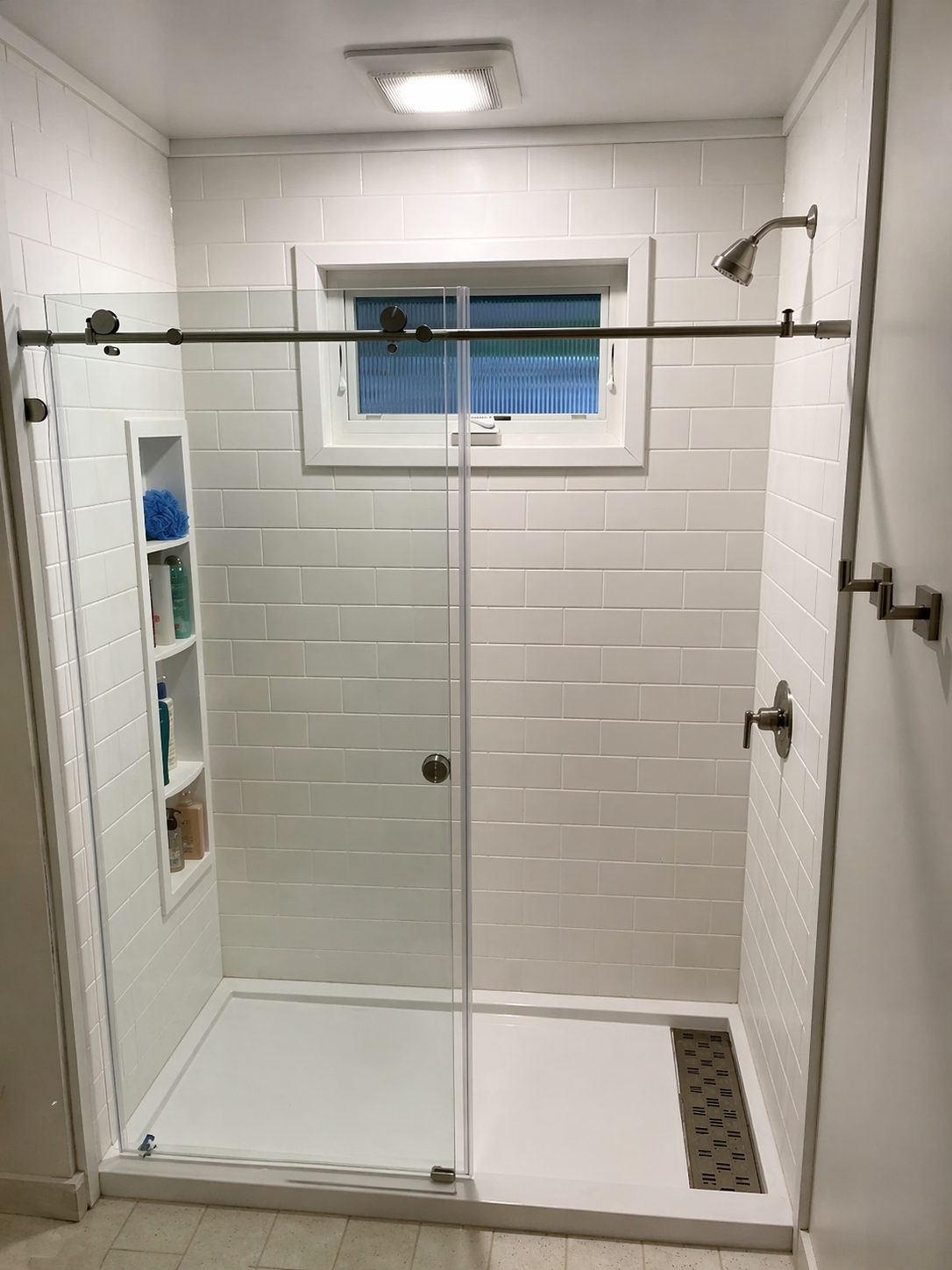 Bright clean bathroom with new walk-in shower and glass door